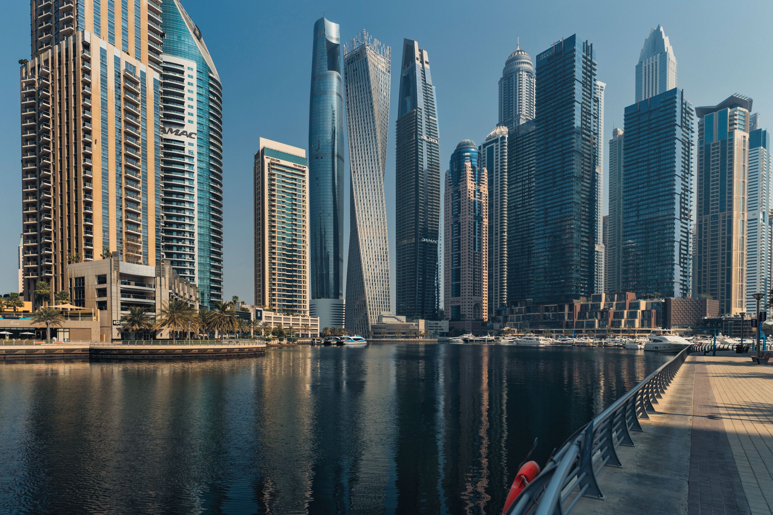 Towers around a Dubai Marina canal by day